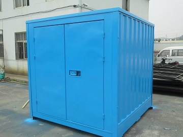 A small blue shipping container house.